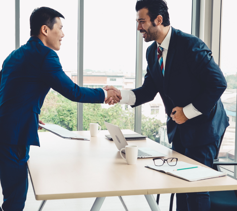 Business professionals shaking hands - hiring talent